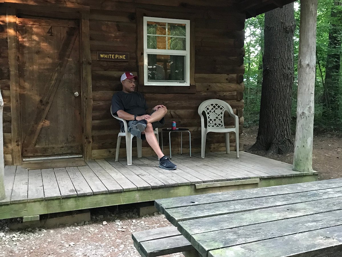 Man sitting outside a Cabin at Hocking Hills Canoe Livery